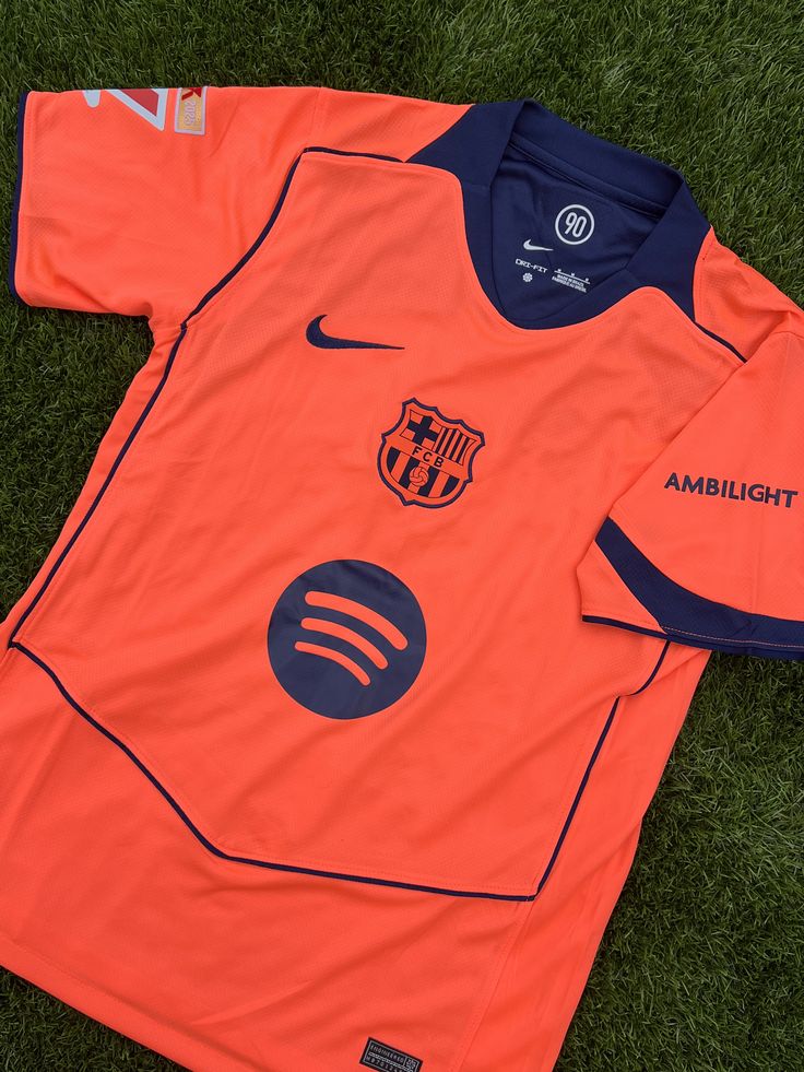 Orange Barcelona away jersey on grass